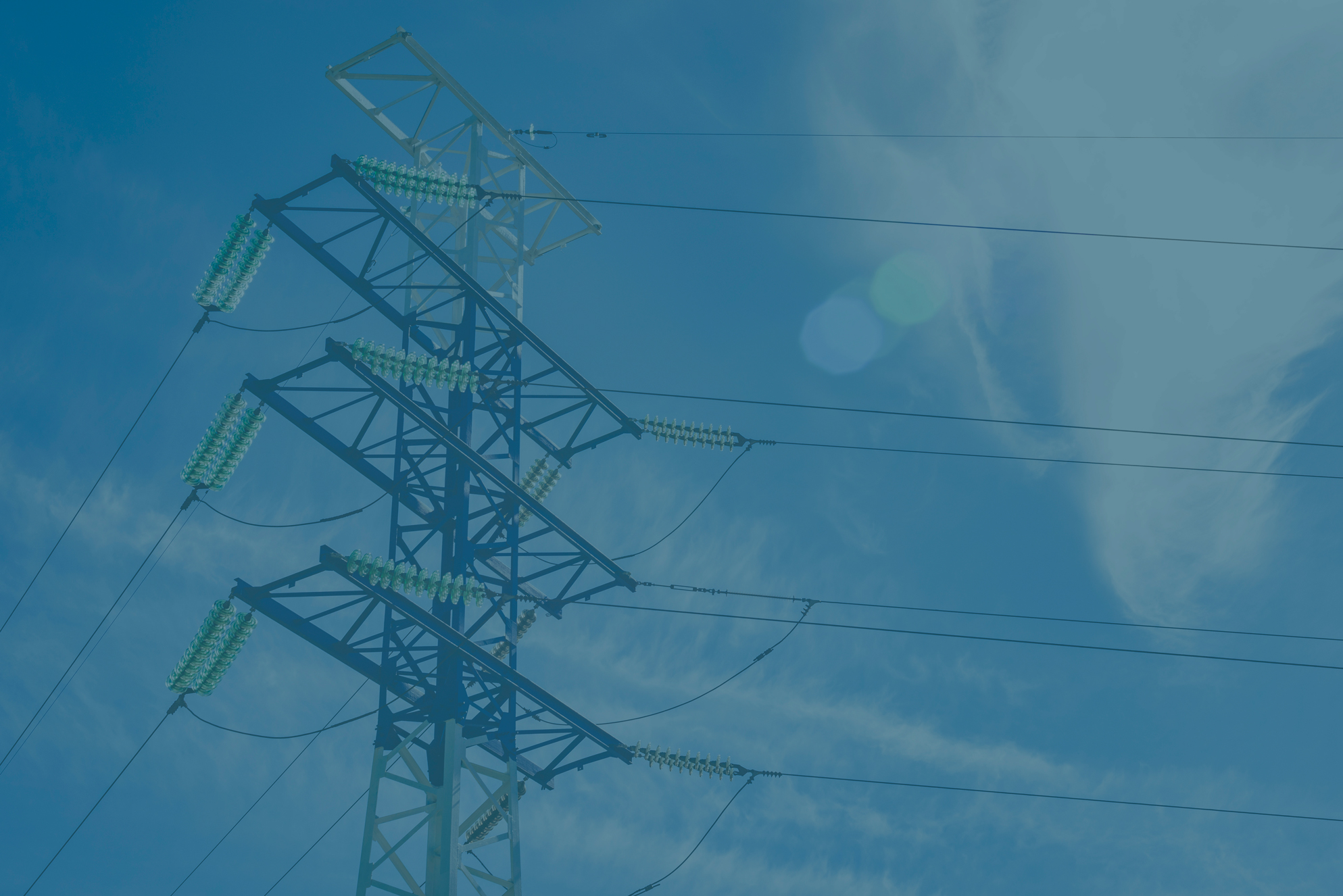 high voltage electric power pylons against blue sky