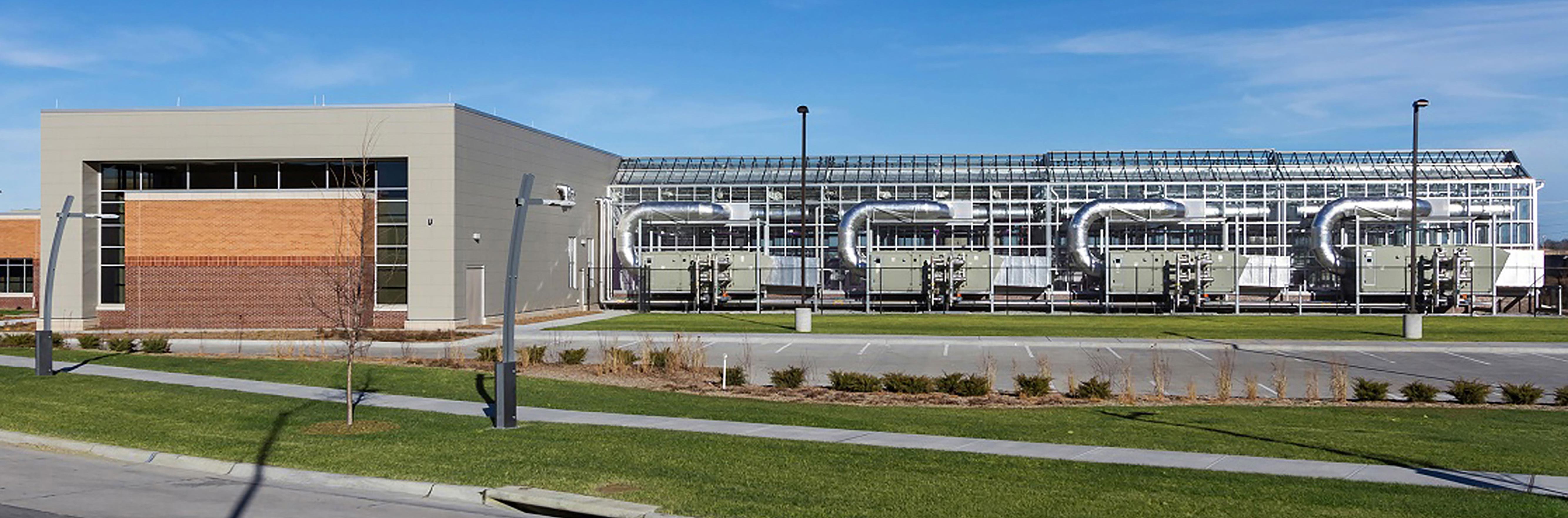 a contemporary greenhouse innovation center on a college campus constructed with large state of the art plumbing, piping and HVAC services