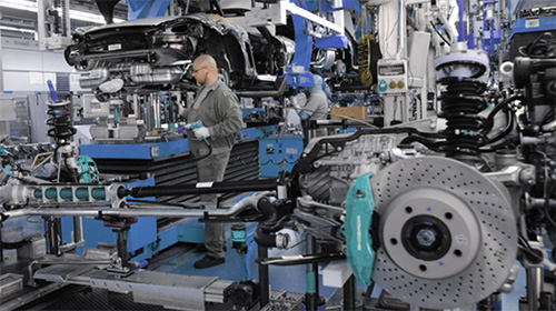 worker on assembly line of an automotive manufacturing plant
